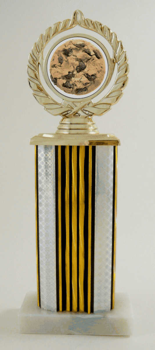 A decorative trophy with a gold laurel wreath top and circular gold medallion, mounted on a striped column featuring vertical gold, black, and white stripes, and a white marble base.