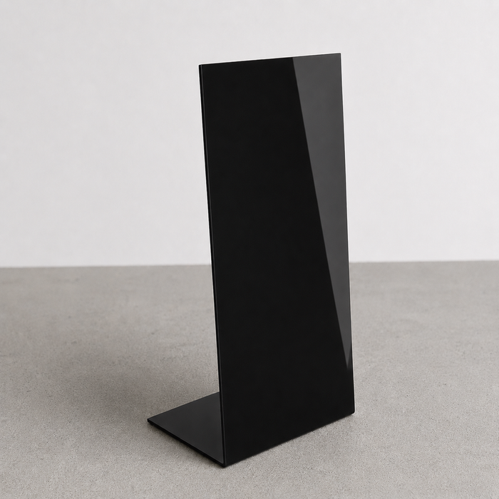 Black opaque acrylic floor sign with a slanted face and flat bent base.