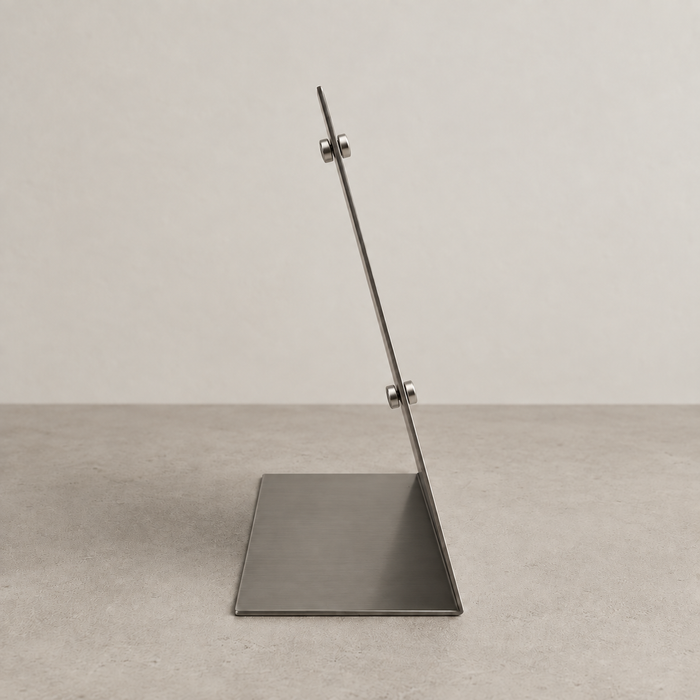Side profile of a stainless steel tabletop stand showing its base and small attached magnets.