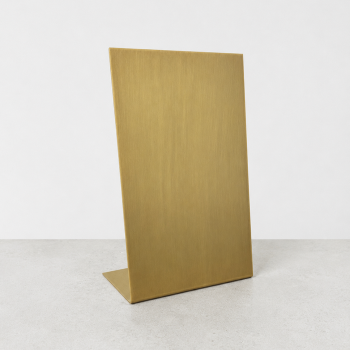 Blank brushed brass tabletop stand in portrait orientation.