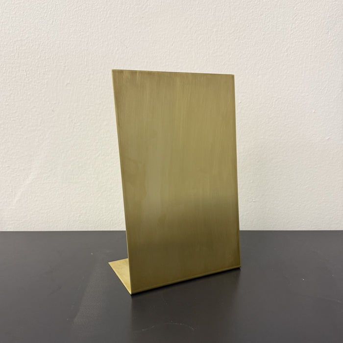 Front angled view of a blank brushed brass tabletop stand.