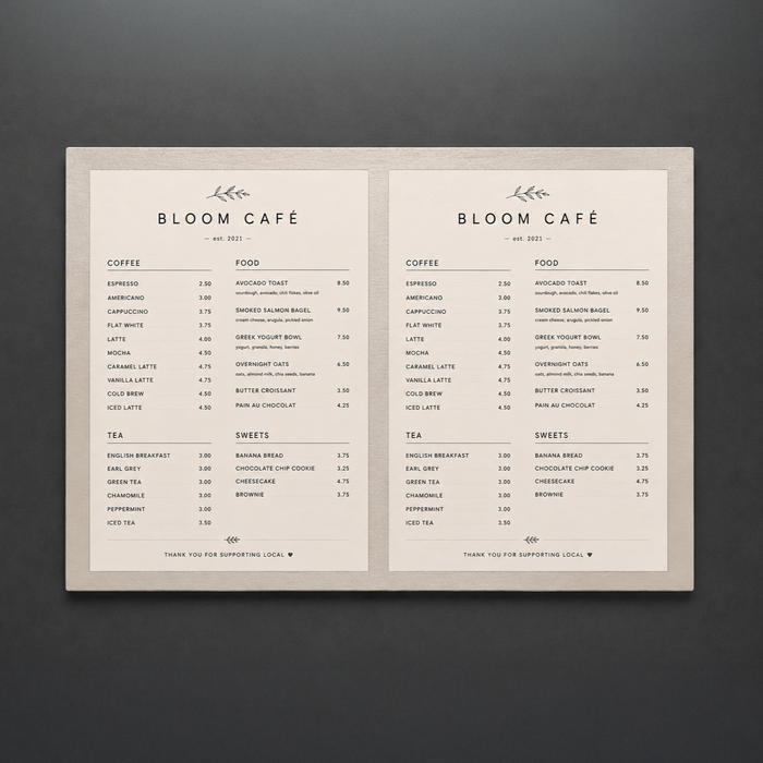 Large landscape stainless steel menu holder displaying two Bloom Café menu sheets.