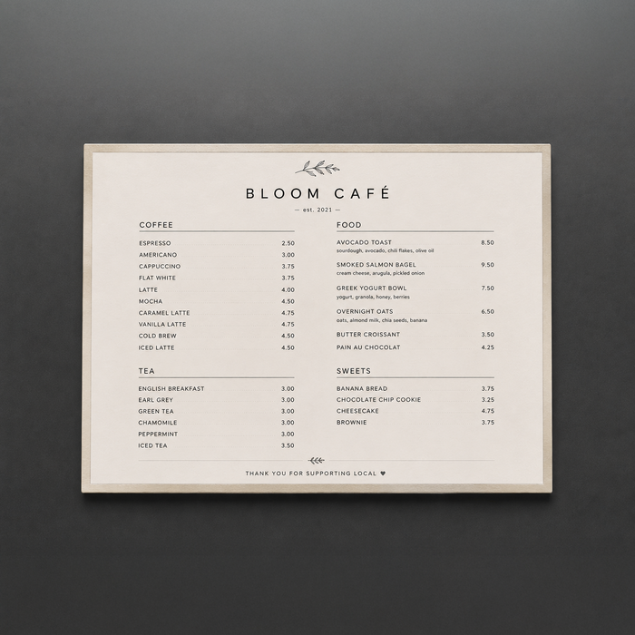 Landscape stainless steel menu holder displaying a Bloom Café menu.