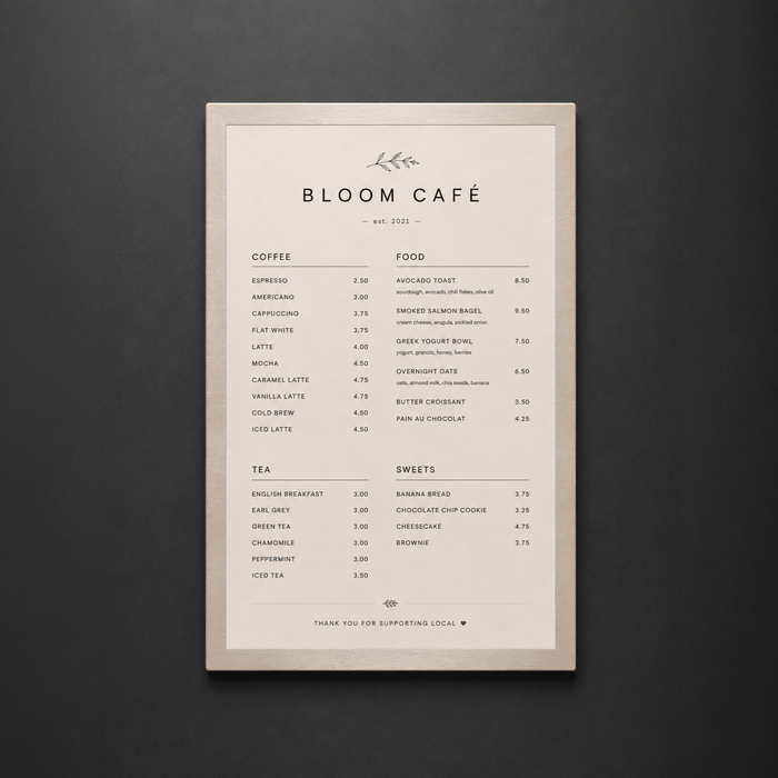 Portrait stainless steel menu holder displaying a Bloom Café menu.