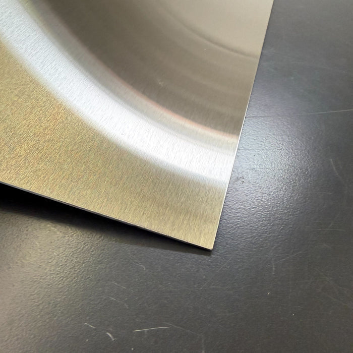 Close-up of the top corner of a stainless steel menu holder.