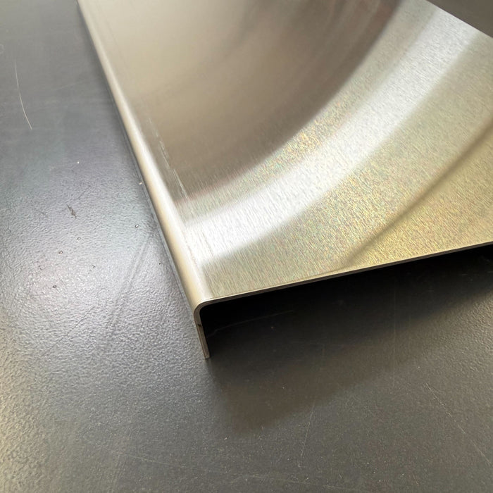 Close-up of the folded left edge of a stainless steel menu holder.