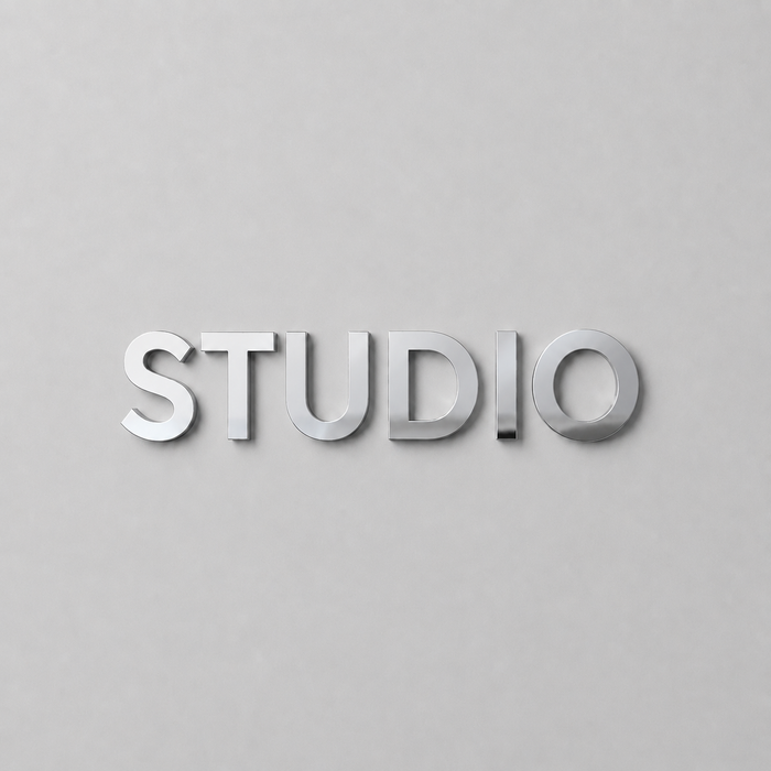 Mirrored stainless steel wall letters spelling Studio.