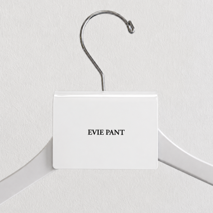 White acrylic hanger sign clip with black Evie Pant lettering.