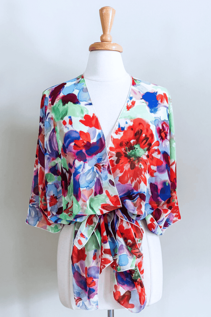 Premium fabric Butterfly Wrap featuring a colorful Jardin floral print with elegant draped styling.
