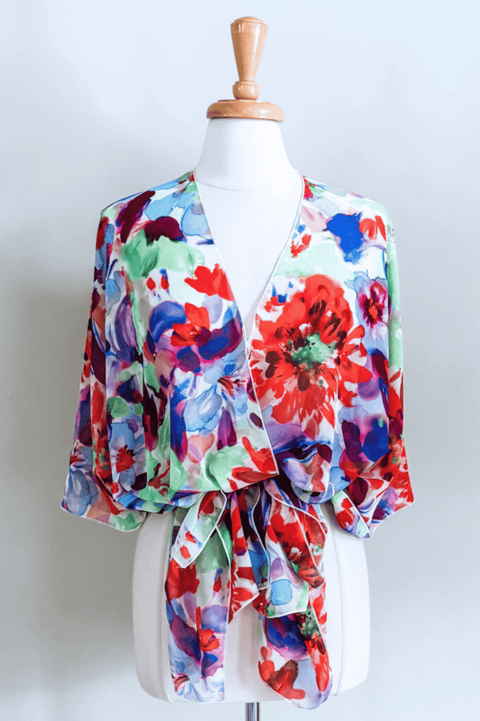 Premium fabric Butterfly Wrap featuring a colorful Jardin floral print with elegant draped styling.