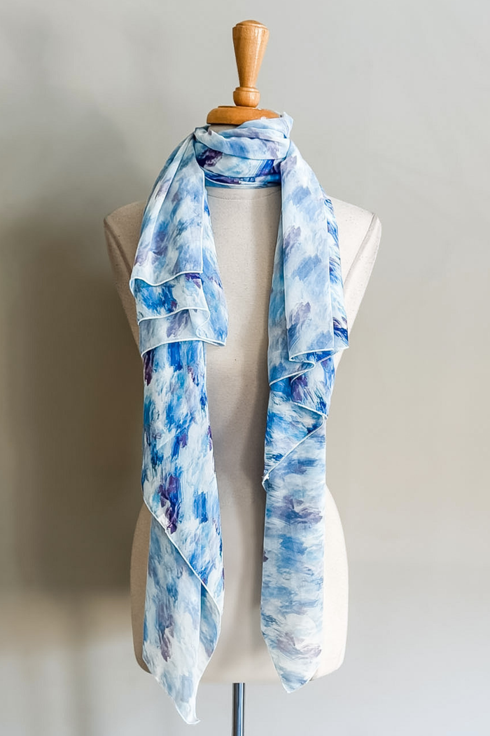 Diane Kroe Butterfly Wrap in Watercolor Wave print styled as a versatile scarf for travel and resort wear