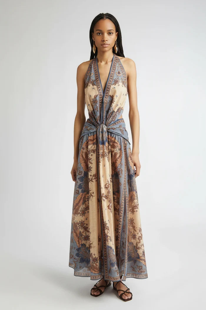 Woman wearing a long, patterned dress on a white background