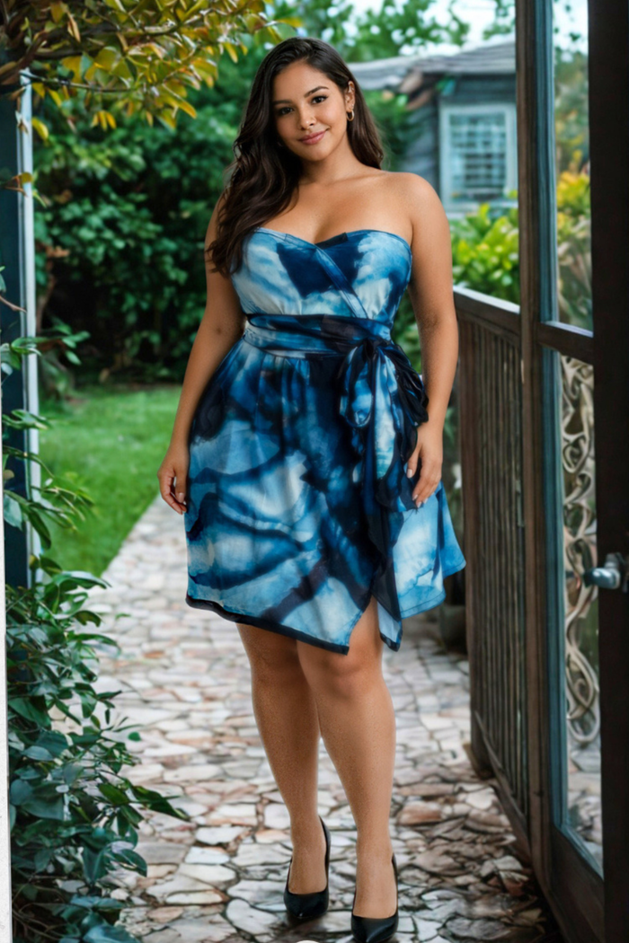 Woman wearing the Sea Oasis print Carry-on Cozy dress with a matching sash standing outdoors on a stone path