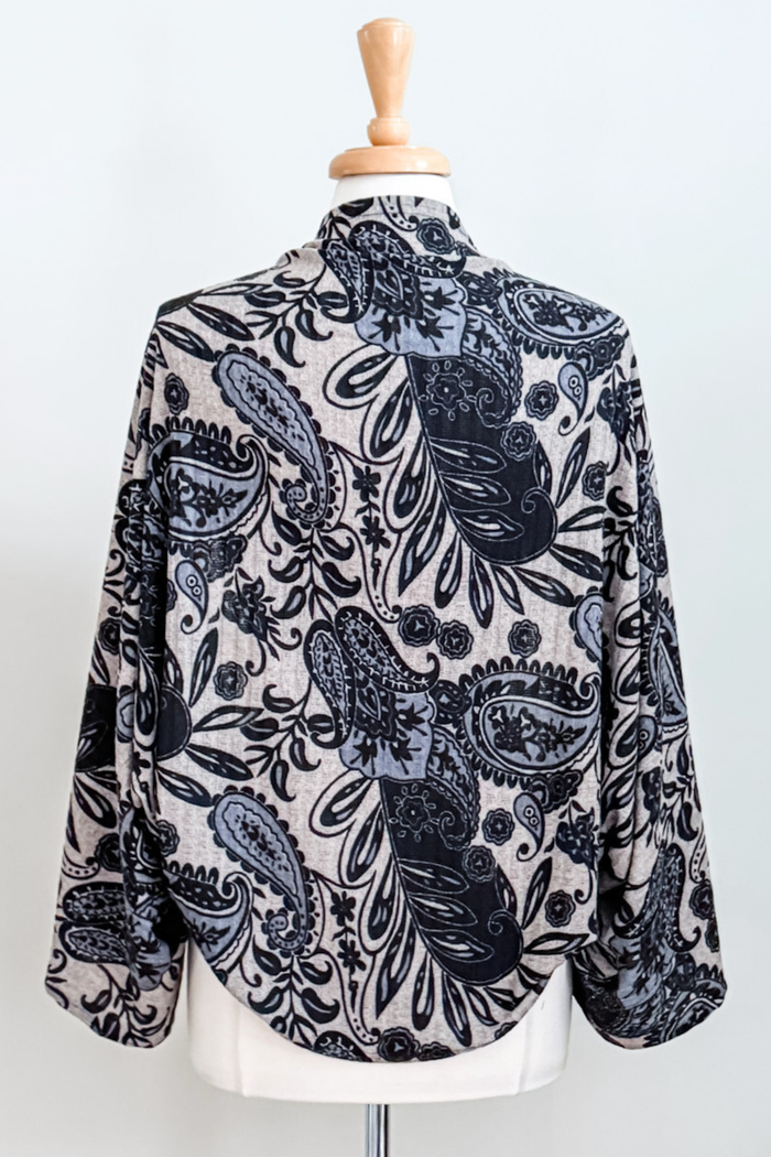 Diane Kroe Carry-on Cozy in blue Spain print styled as wrap top.