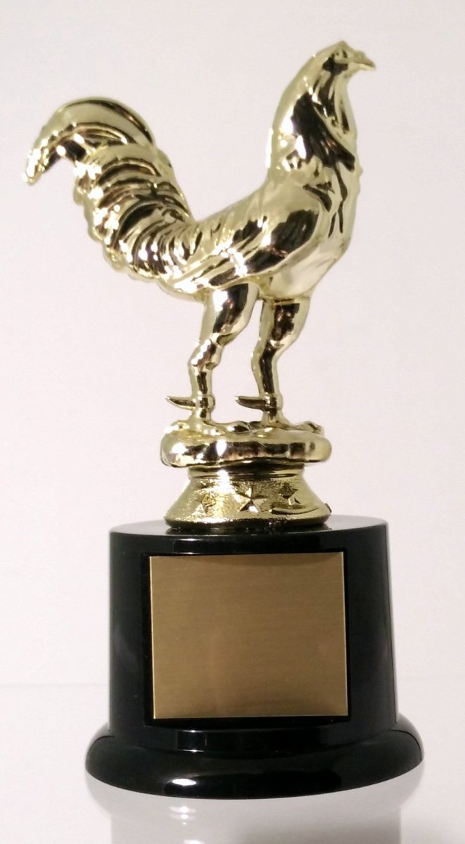 A trophy featuring a gold-colored rooster figurine mounted on a black round base with a gold engraving plate