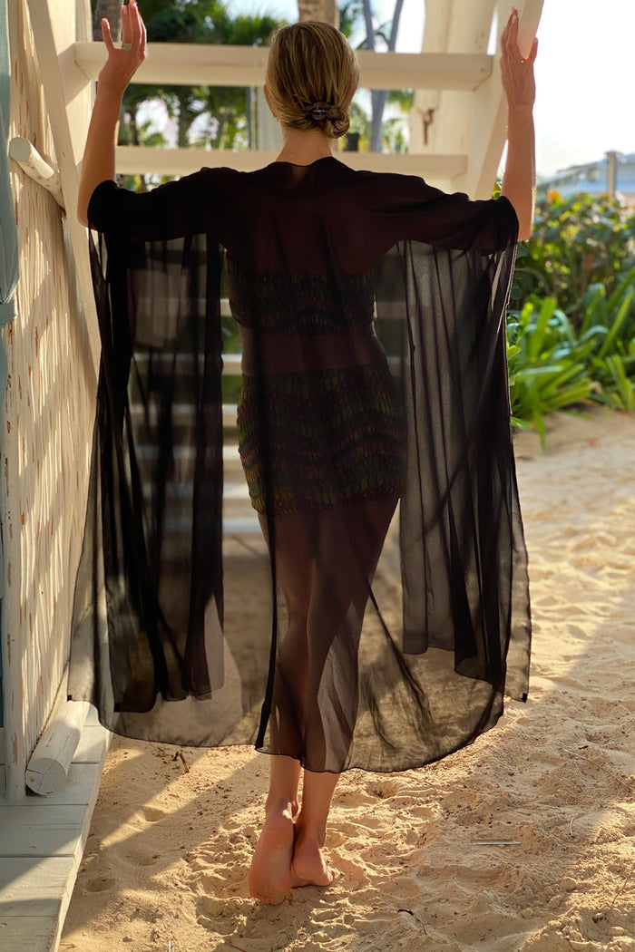 Diane Kroe Black Mariposa Kaftan styled as an elegant dress cover-up for beach or resort wear