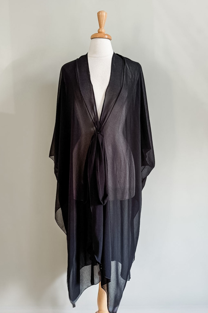 Diane Kroe Black Mariposa Kaftan styled as an elegant dress cover-up for beach or resort wear