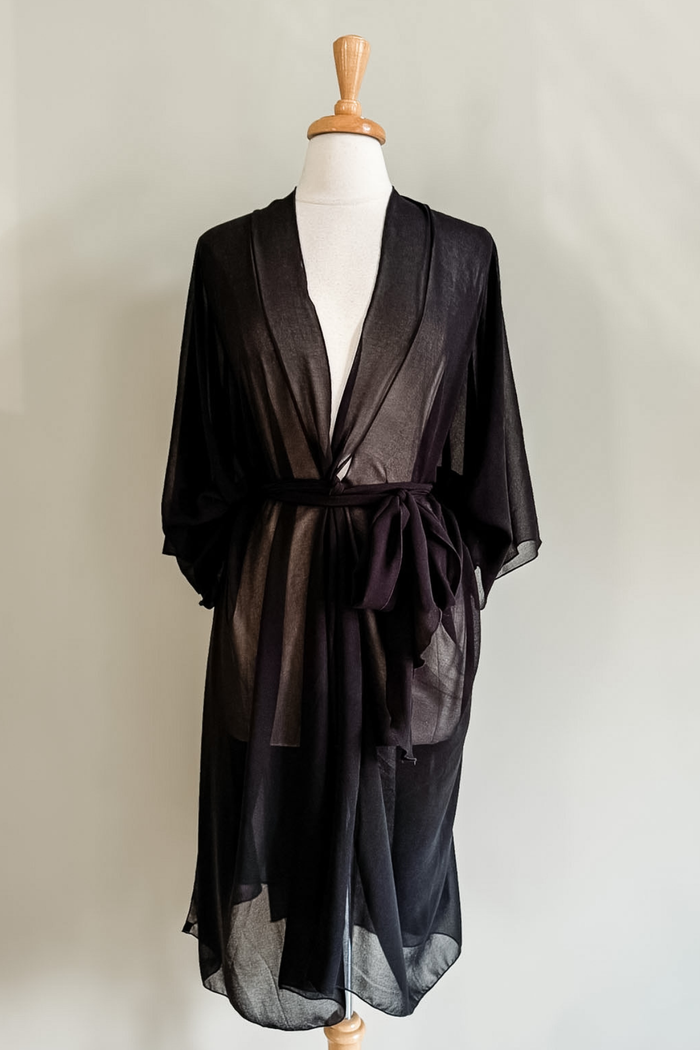 Diane Kroe Black Mariposa Kaftan styled as an elegant dress cover-up for beach or resort wear