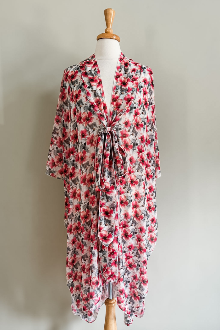 Diane Kroe Mariposa Kaftan in Pink Poppy print styled as an elegant dress cover-up for beach or resort wear