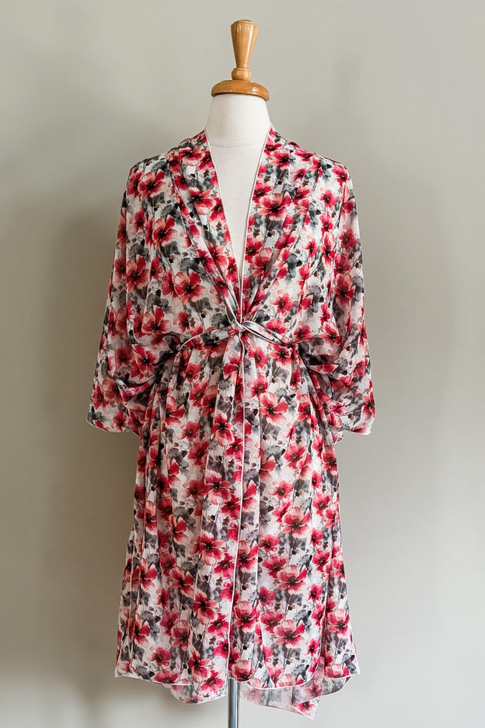 Diane Kroe Mariposa Kaftan in Pink Poppy print styled as an elegant dress cover-up for beach or resort wear