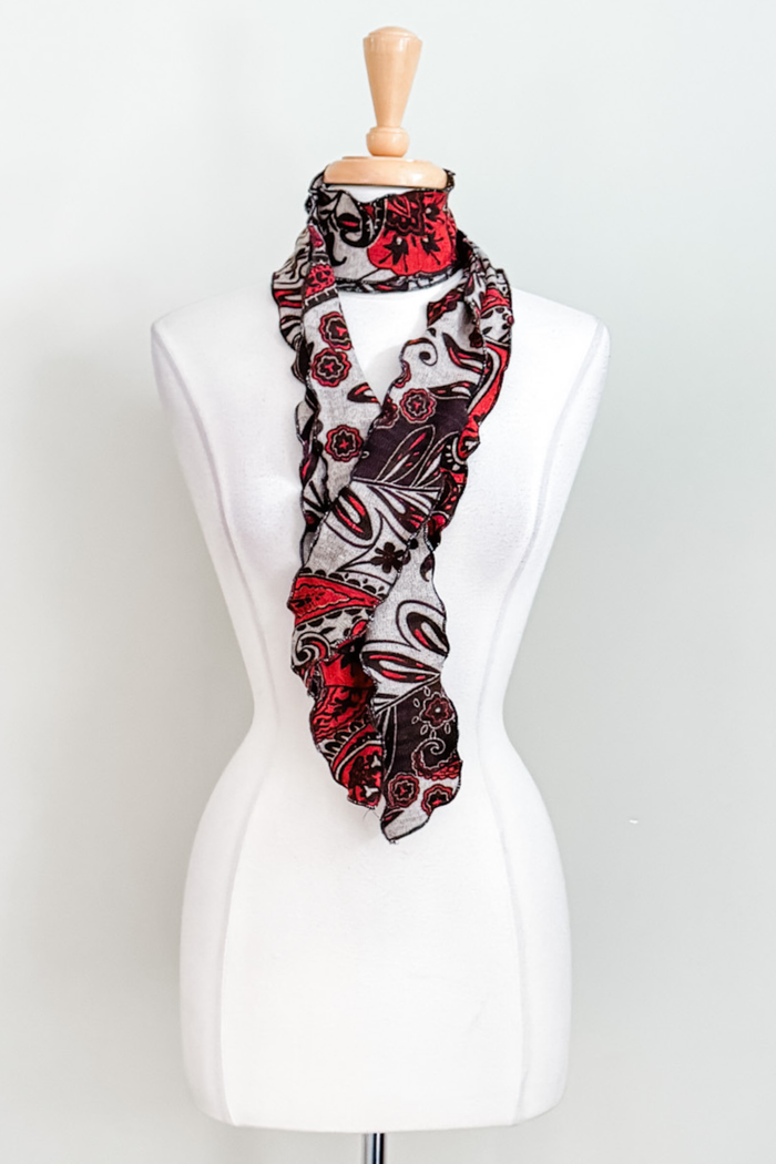 Matching sash in red Spain print worn as a scarf