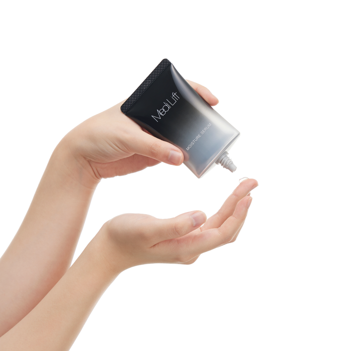 Hand holding a black and silver Medilift device against a white background