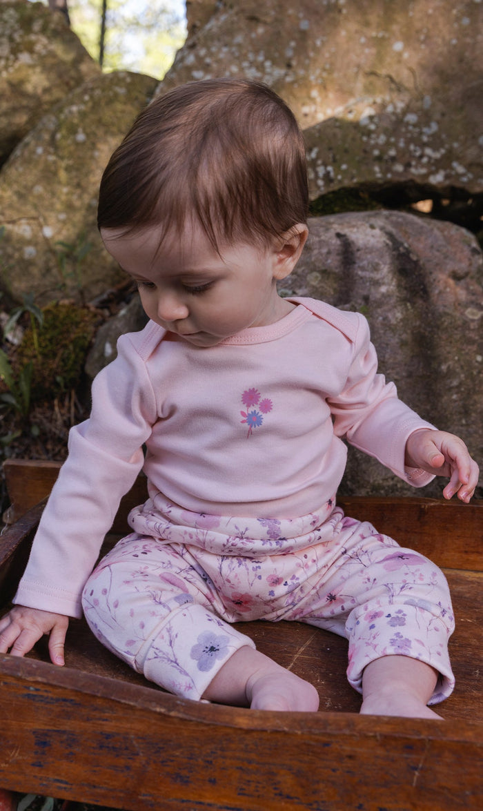 Deux par Deux baby girls evolutive pants, pink watercolor floral print, lifestyle view