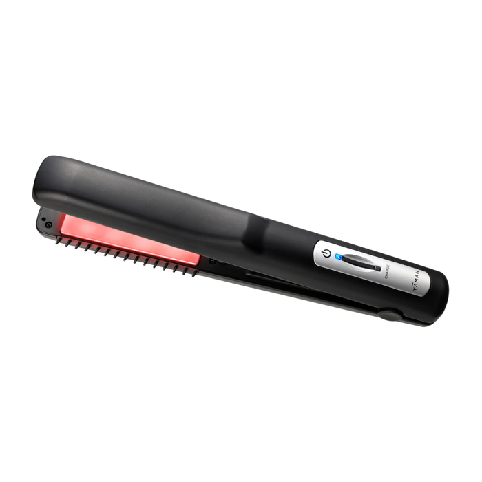 Black hair straightener with a red heating element on a white background