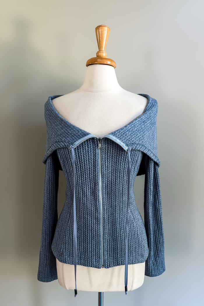 Blue knitted convertible hoodie on a mannequin against a plain background
