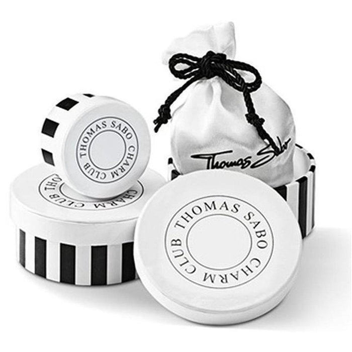 Heart-shaped charm in elegant black and white packaging.