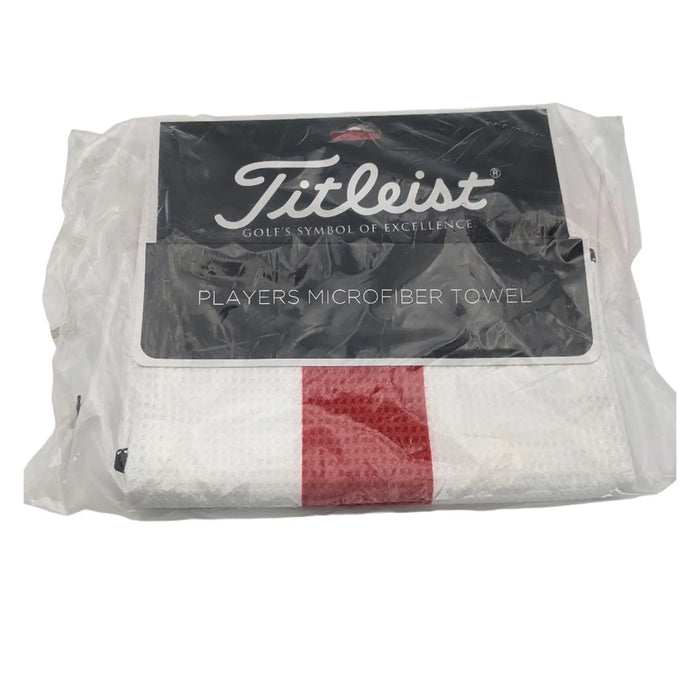 White microfiber towel packaged in plastic with a black label showcasing the Titleist logo and the text "PLAYERS MICROFIBER TOWEL" is visible in the foreground.